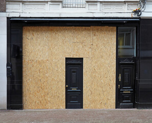 boarded up store window