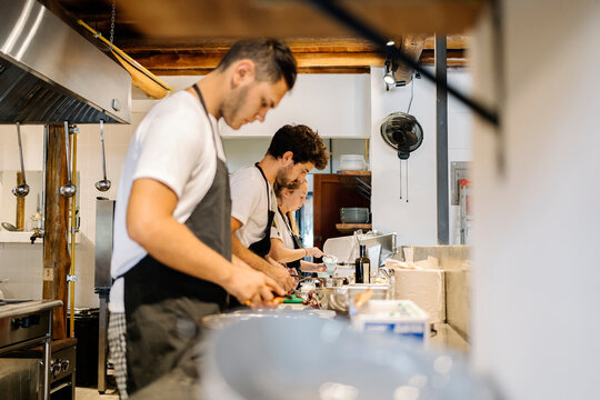 Focused Chefs Cooking in Kitchen