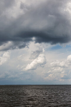 storm overtaking sunny skies over water