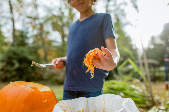  Boy holds out spoon of pumpkin seeds
