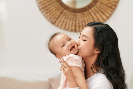 Little Child Smiling And Happy With Mom