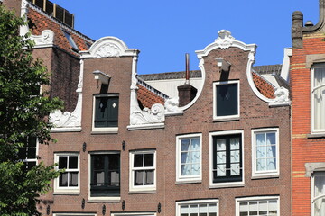 Fototapeta na wymiar Amsterdam Traditional Canal House Facades with Neck and Bell Gables