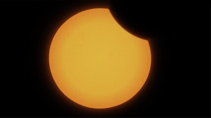 Time lapse of partial solar eclipse close up. The moon mostly covers the visible sun. Natural phenomenon of near full orange sun eclipse. Moon silhuette cast shadows covering yellow sun. - Powered by Adobe
