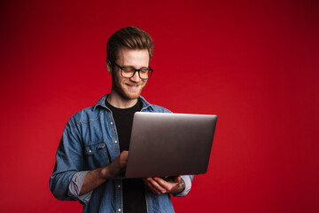 Happy smiling young man in casual clothes standing