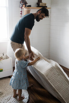 father and daughter replace cot with mattress