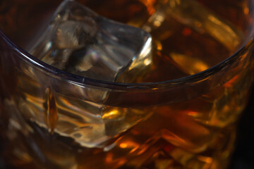 whiskey with ice in glasses close-up, strong alcohol