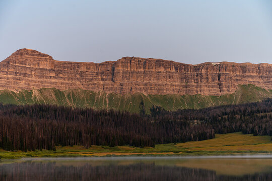 A textured rock face across the lake