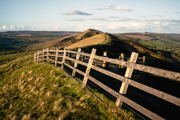 a close up of a hillside next to a wooden fence - Mam tor
