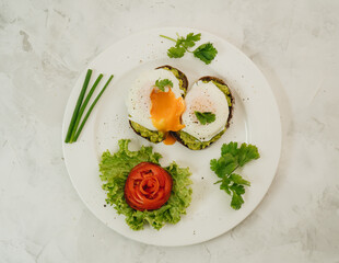 Poached eggs with avocado on sourdough toasts on white background