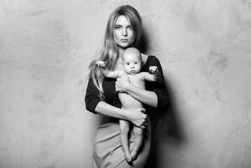 Beautiful well dressed and luxury mother with her cute baby boy