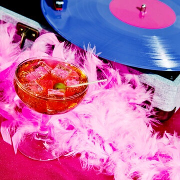 cocktail and violet record in a portable turntable