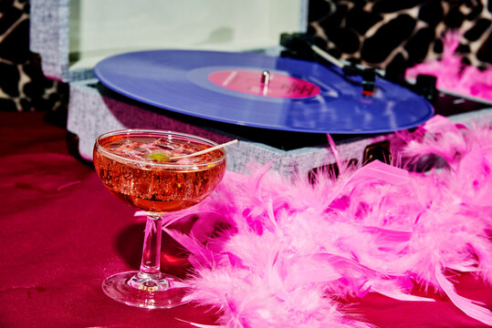 feather boa, cocktail glass, and portable turntable