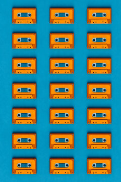 top down view of Orange musicassette on blue background