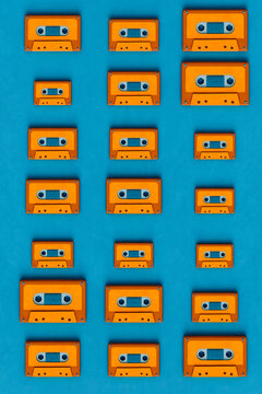 pattern of Orange musicassette on blue background - different sizes