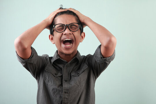 Portrait of a young boy with a screaming face