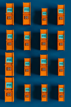 top down view of Orange arcade cabinet on blue background