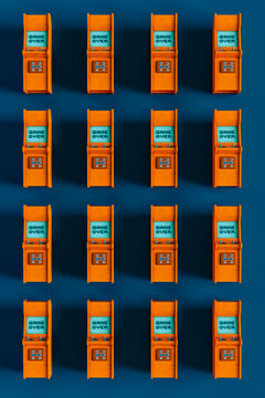 top down view of Orange arcade cabinet on blue background