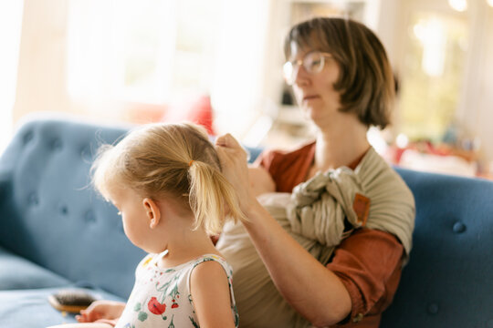 mother fixing little girl's hair
