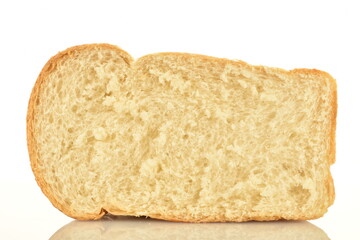 One half of white flavored wheat bread, close-up, isolated on white.
