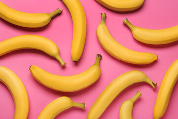 Ripe yellow bananas on pink background, flat lay © New Africa
