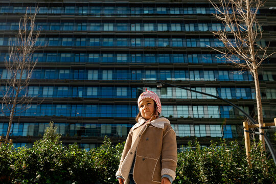 little girl standing in   urban skyline