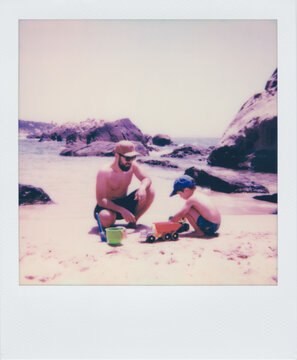 Polaroid of father and son play with toys on the shore of the beach