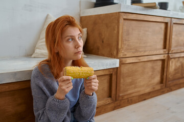 woman vegetarian eats corn at home 