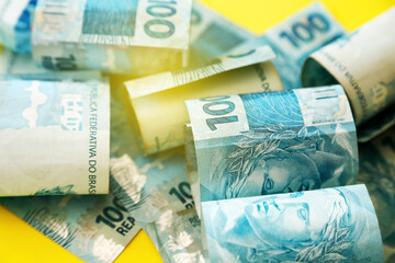 money from brazil - detail in scattered hundred reais bills