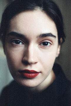 Close up portrait of brunette girl with red lips