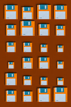 top down view of Blue and orange Floppy disks on brown background