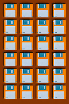 top down view of Blue and orange Floppy disks on brown background