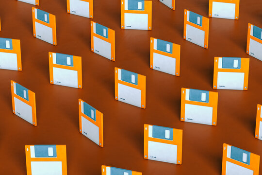 pattern of Blue and orange Floppy disks on brown background arranged differently
