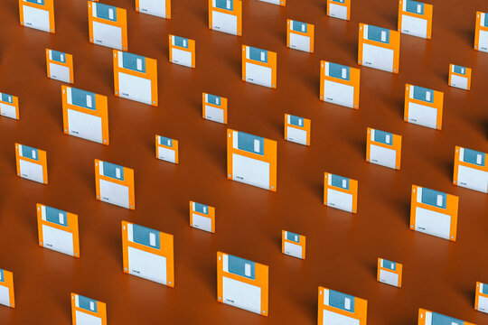 pattern of Blue and orange Floppy disks on brown background in different sizes