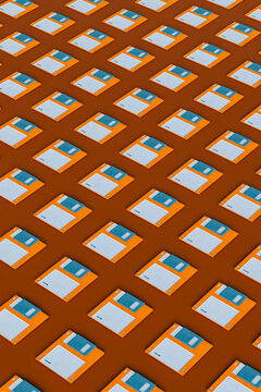 Blue and orange Floppy disks on brown background
