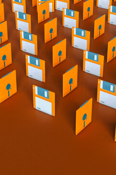 Blue and orange Floppy disks on brown background