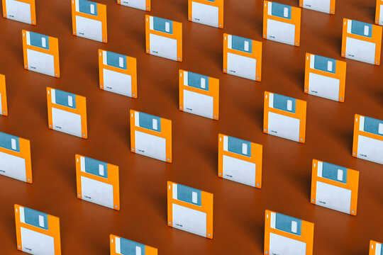 Blue and orange Floppy disks on brown background