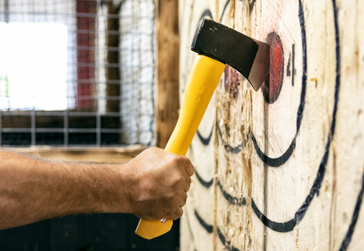 Man Removing Axe From Target Bullseye