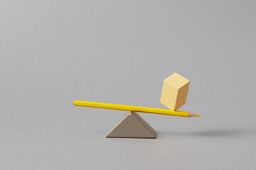 Yellow eraser balancing on pencil