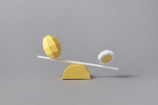 Papercraft eggs balancing on plank