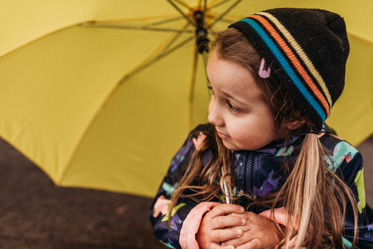 Portrait of young girl with yellow umbrella