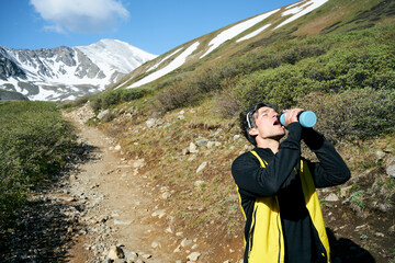 Man drinking water during a hike