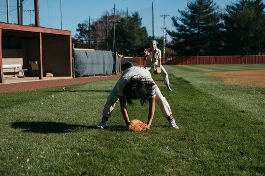 Young women playing catch on a baseball field