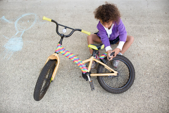 Girl screws fender on bike