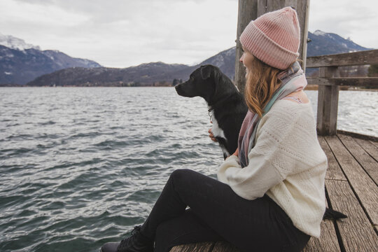 young female with dog enjoying time outdoors