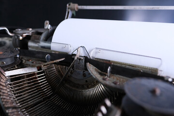 old typewriter on table, blank white sheet for text, mockup, retro style, concept of works of a...