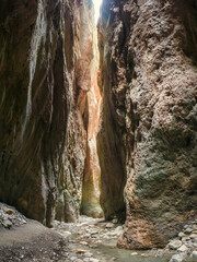 Sunlight in a mountain gorge. Karadakh gorge with sunlight in Dagestan. Vertical panorama.