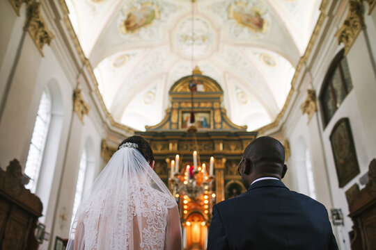 Bride and groom facing the altar. 