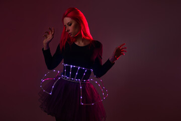 Light show, suit with LEDs. Young beautiful woman in a luminous suit