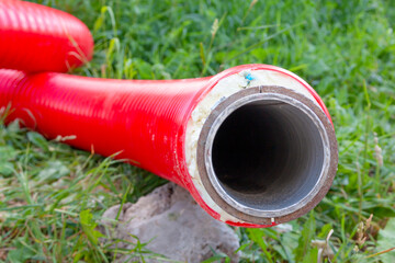 The red pipe is prepared for the replacement of the water supply. Replacement of the city pipeline.