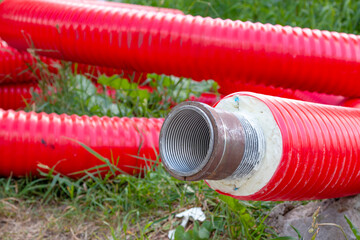 The red pipe is prepared for the replacement of the water supply. Replacement of the city pipeline.